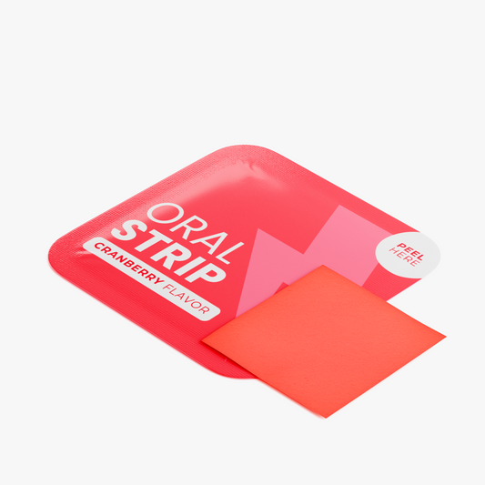 Single NUTRIO Focus + Energy oral strip in Cranberry flavor shown with its peel-open red pouch