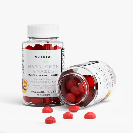 NUTRIO Hair, Skin & Nails gummies spilling from an open bottle next to an upright Passion Fruit bottle