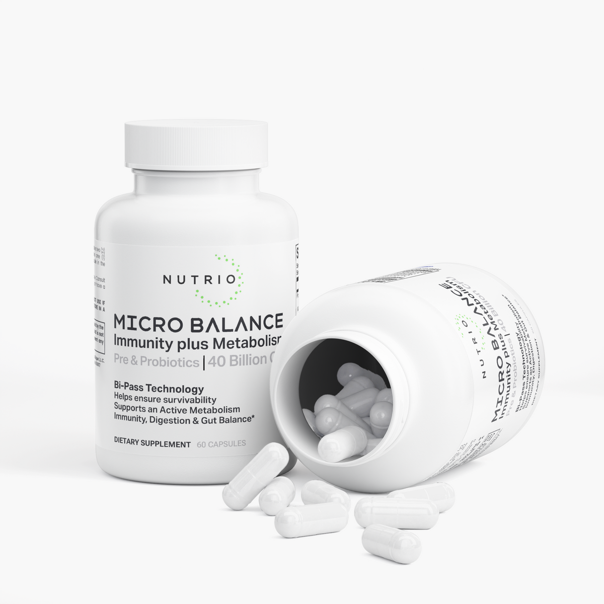 NUTRIO Micro Balance bottle beside an open bottle with white capsules spilling onto the surface