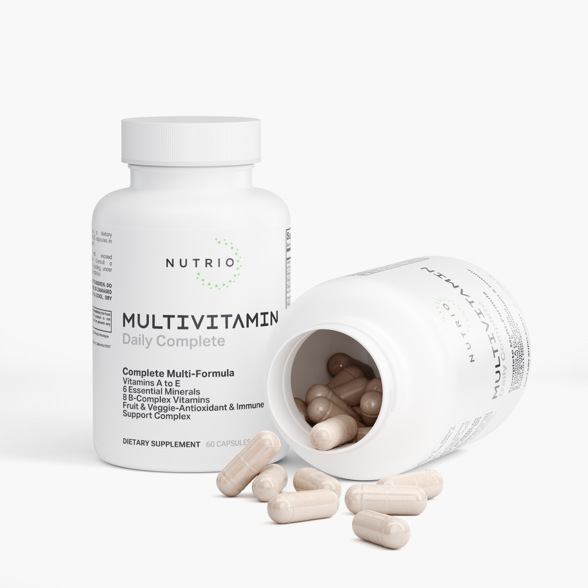 NUTRIO Daily Complete Multivitamin bottle beside an open bottle with capsules spilling out