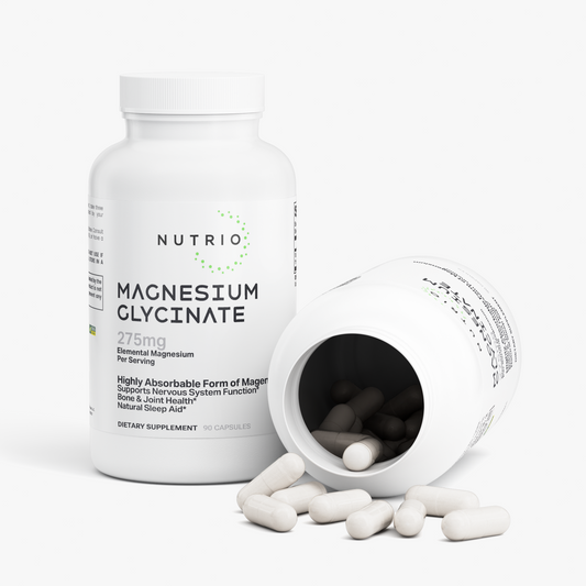 NUTRIO Magnesium Glycinate bottle beside an open bottle with white capsules spilling out