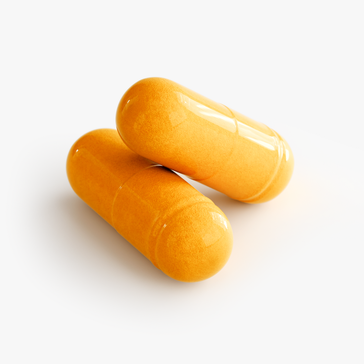 Close-up of two orange NUTRIO CoQ10 Ubiquinone capsules