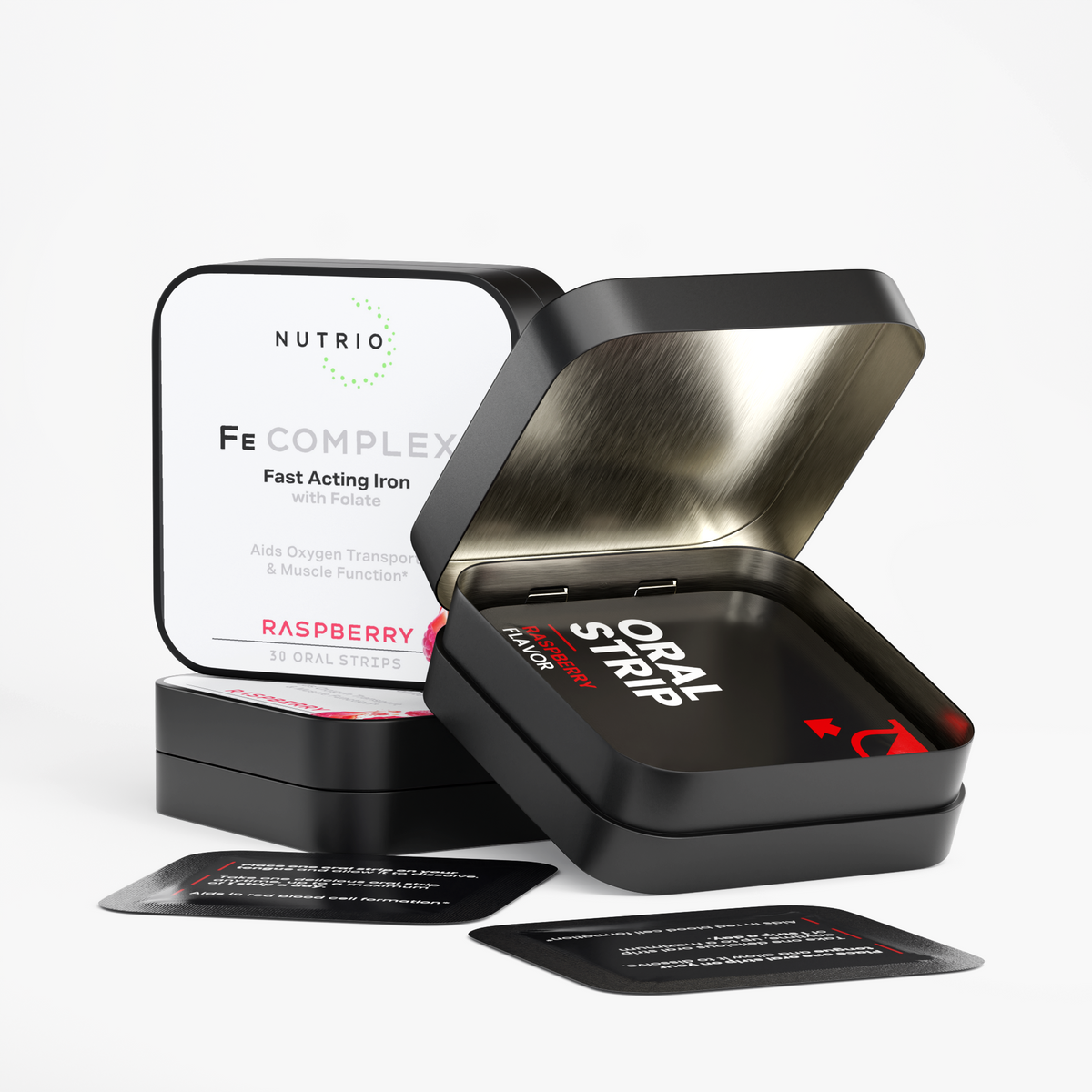 Open NUTRIO Fe Complex tin with individually wrapped Raspberry oral strips, closed tin in the background