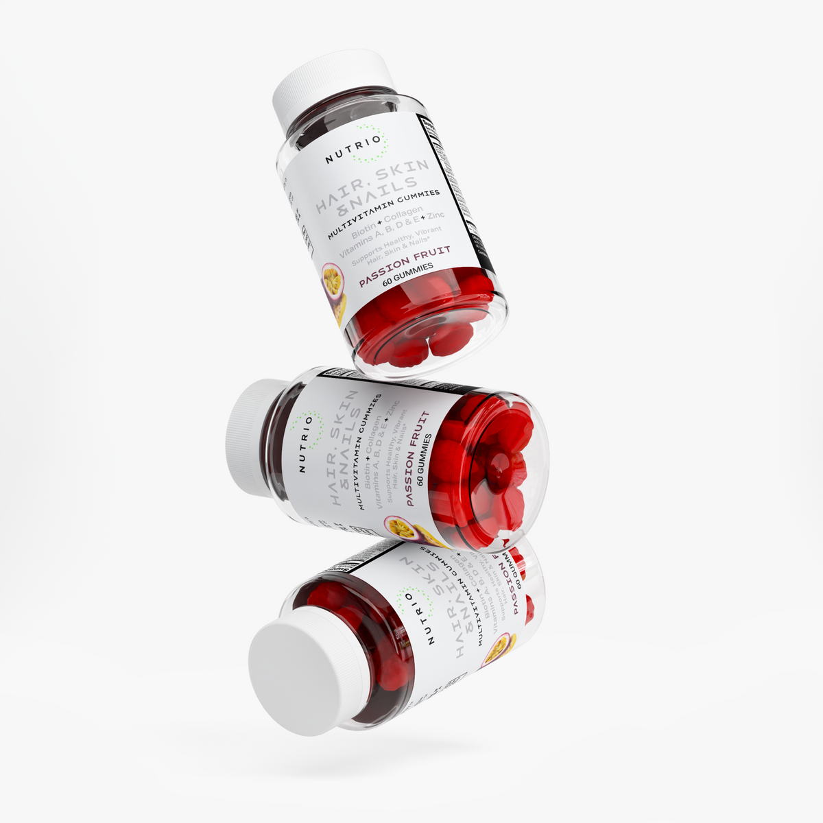 Three NUTRIO Hair, Skin & Nails Passion Fruit gummy bottles stacked in mid-air