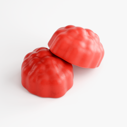 Close-up of two red NUTRIO Hair, Skin & Nails Passion Fruit multivitamin gummies