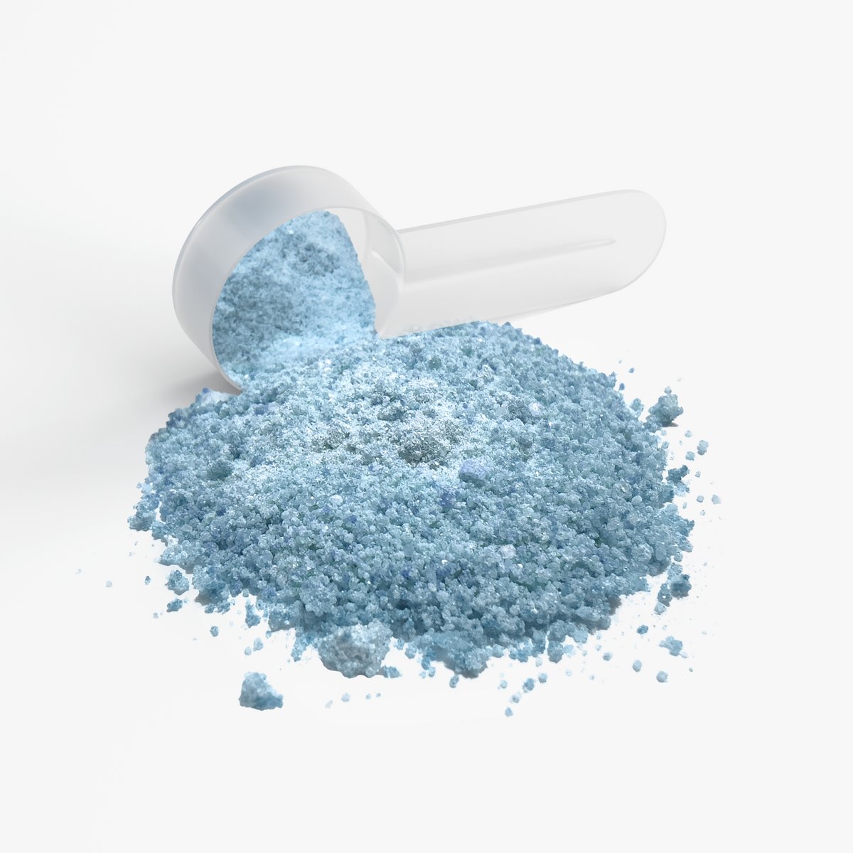 Close-up of NUTRIO Focus + Energy Sour Gummi Worm blue powder spilling from a clear scoop
