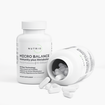NUTRIO Micro Balance bottle beside an open bottle with white capsules spilling onto the surface