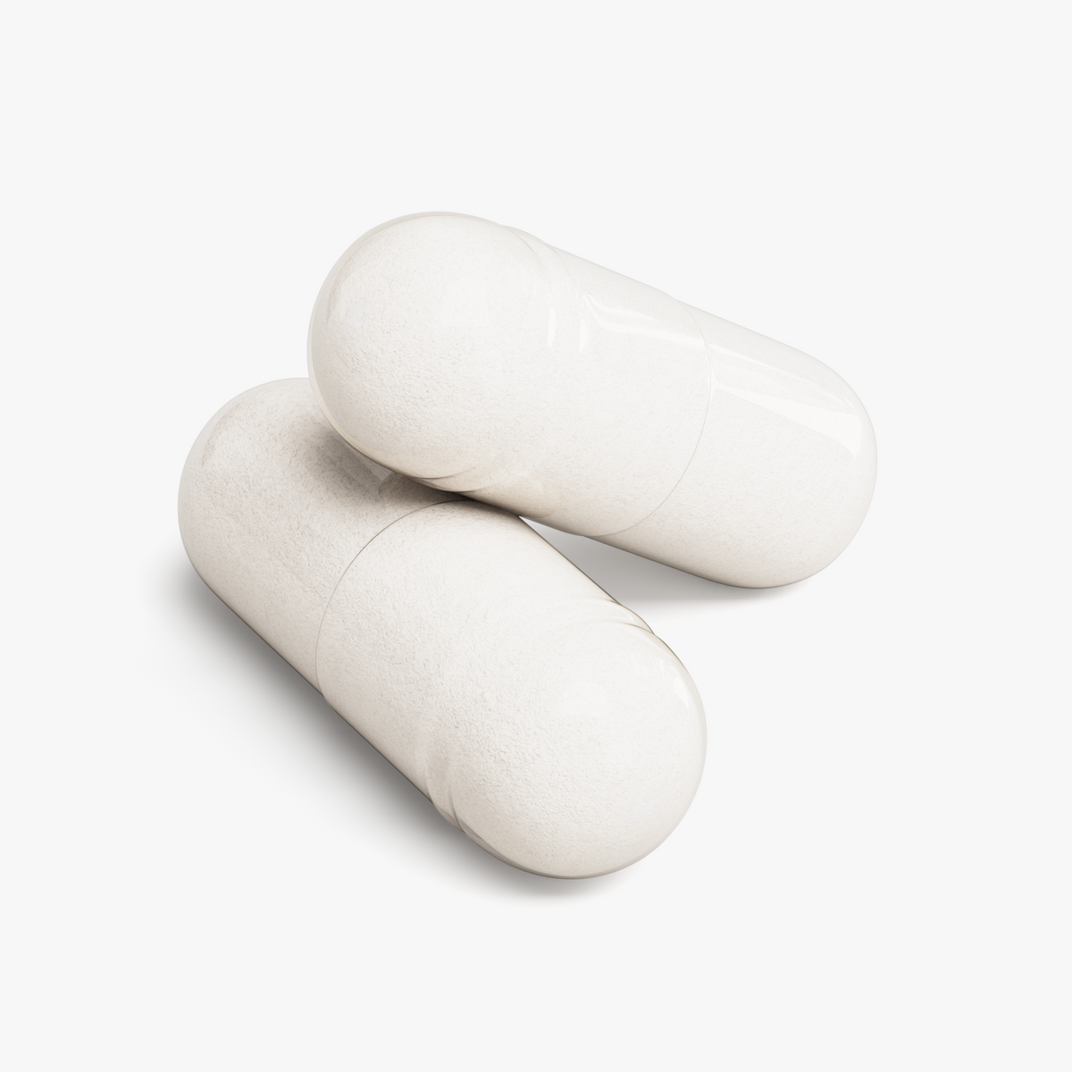 Close-up of two white NUTRIO Magnesium Glycinate capsules on a white background