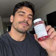 Man taking a selfie with NUTRIO Hair, Skin & Nails Passion Fruit multivitamin gummies
